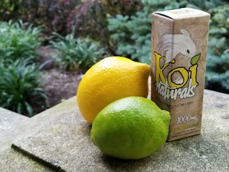 yellow lemon beside brown and white labeled box