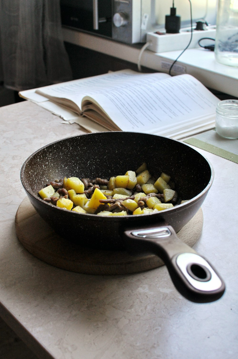 black frying pan with yellow and brown food