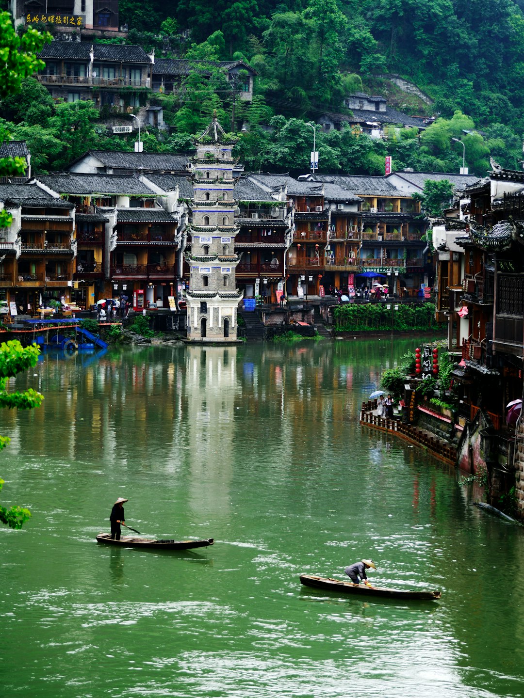 man riding on boat on river during daytime