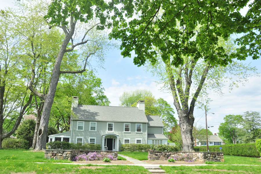Classic gray center-hall colonial with stone wall — Darien