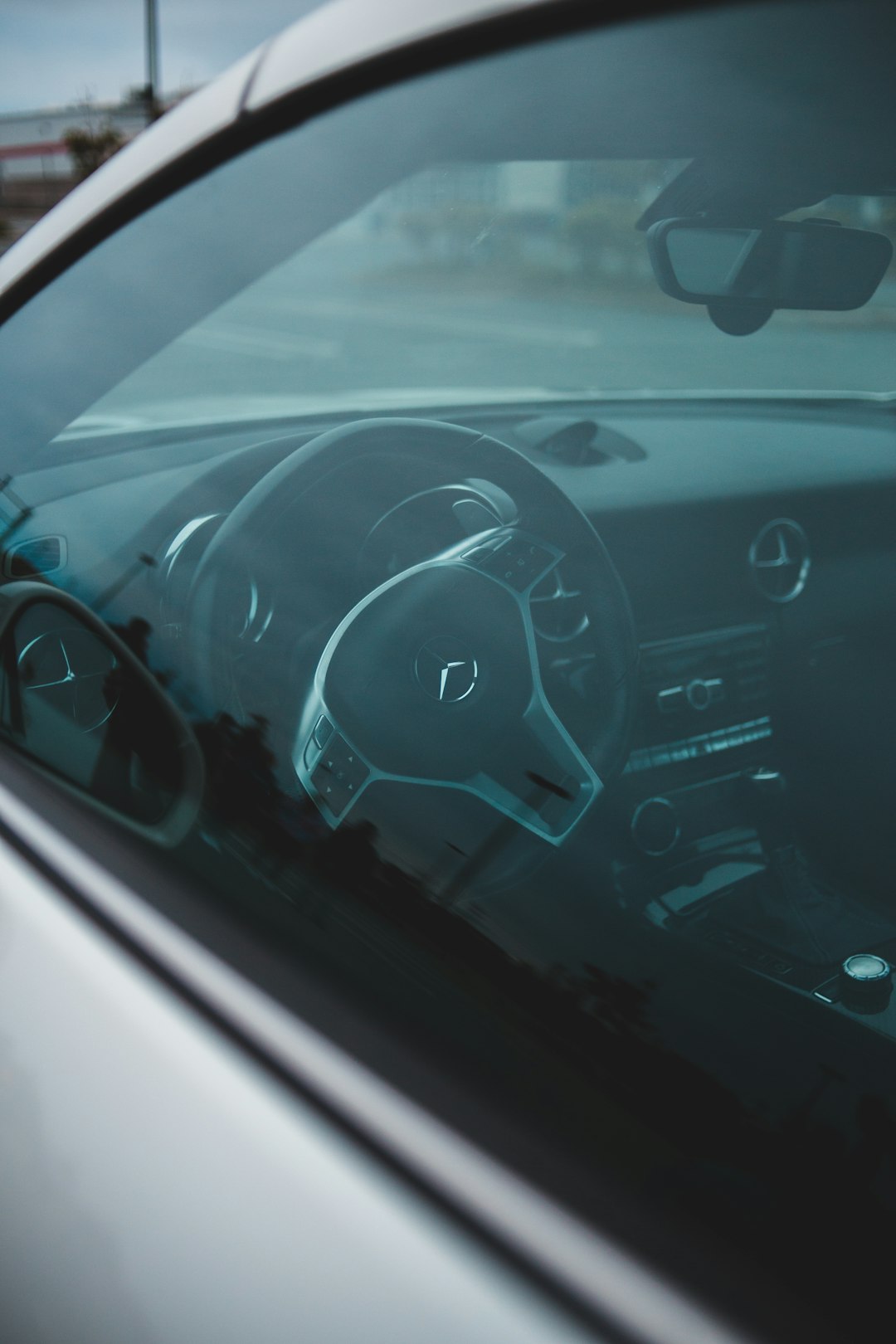 black car dashboard with white and black steering wheel