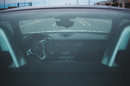 Inside view showing the comfortable interior of a Zelldrive rental car with city streets visible through the windshield.