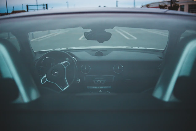 A student focused behind the wheel of a realistic driving simulator in a cozy classroom.