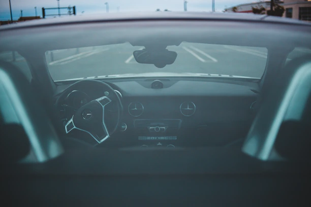 Close-up of a sleek dashcam mounted inside a car, capturing a clear view of the road ahead.