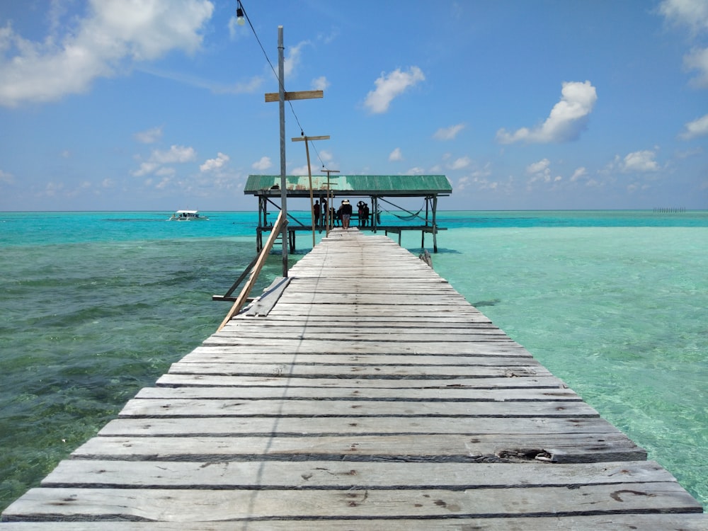 brown wooden dock on sea during daytime