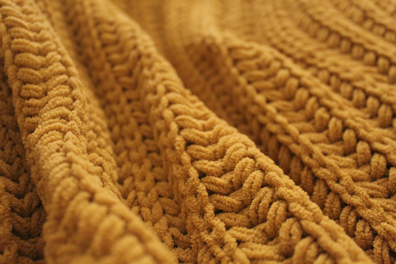 Extra-fine merino knit up close, rib and stitch texture filling the frame