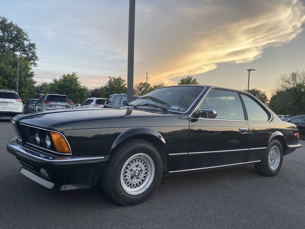 black coupe on parking lot during daytime