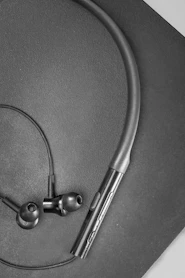 silver earbuds on black textile