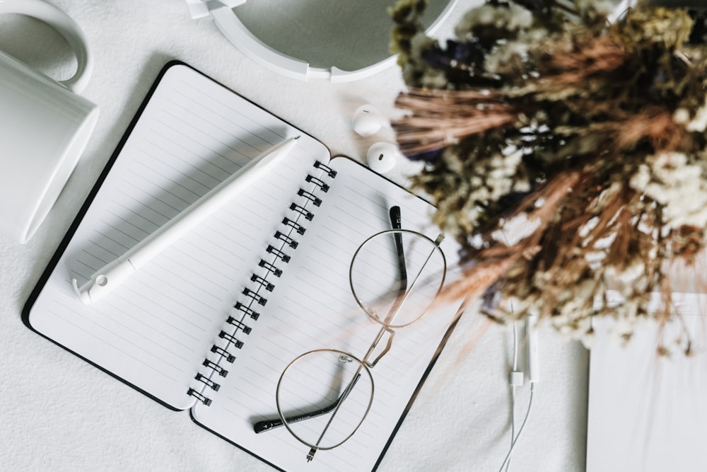 black framed eyeglasses on white plastic table