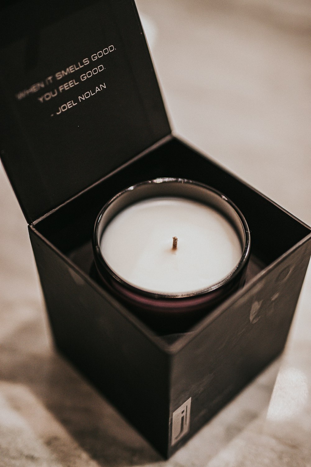 white candle in black box