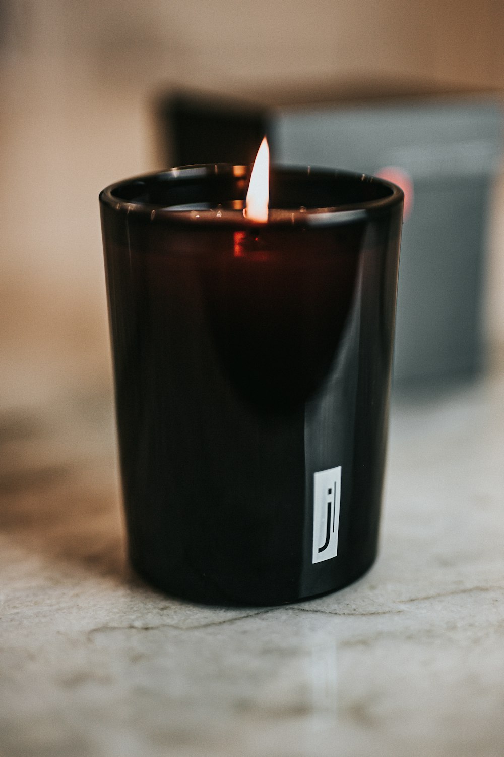 black ceramic mug with lighted candle