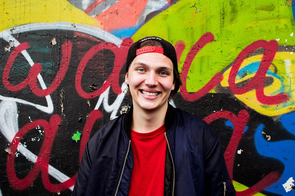 man in black zip up jacket smiling