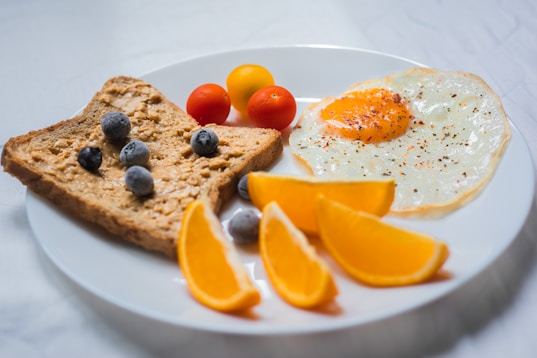 sliced orange fruit on white ceramic plate