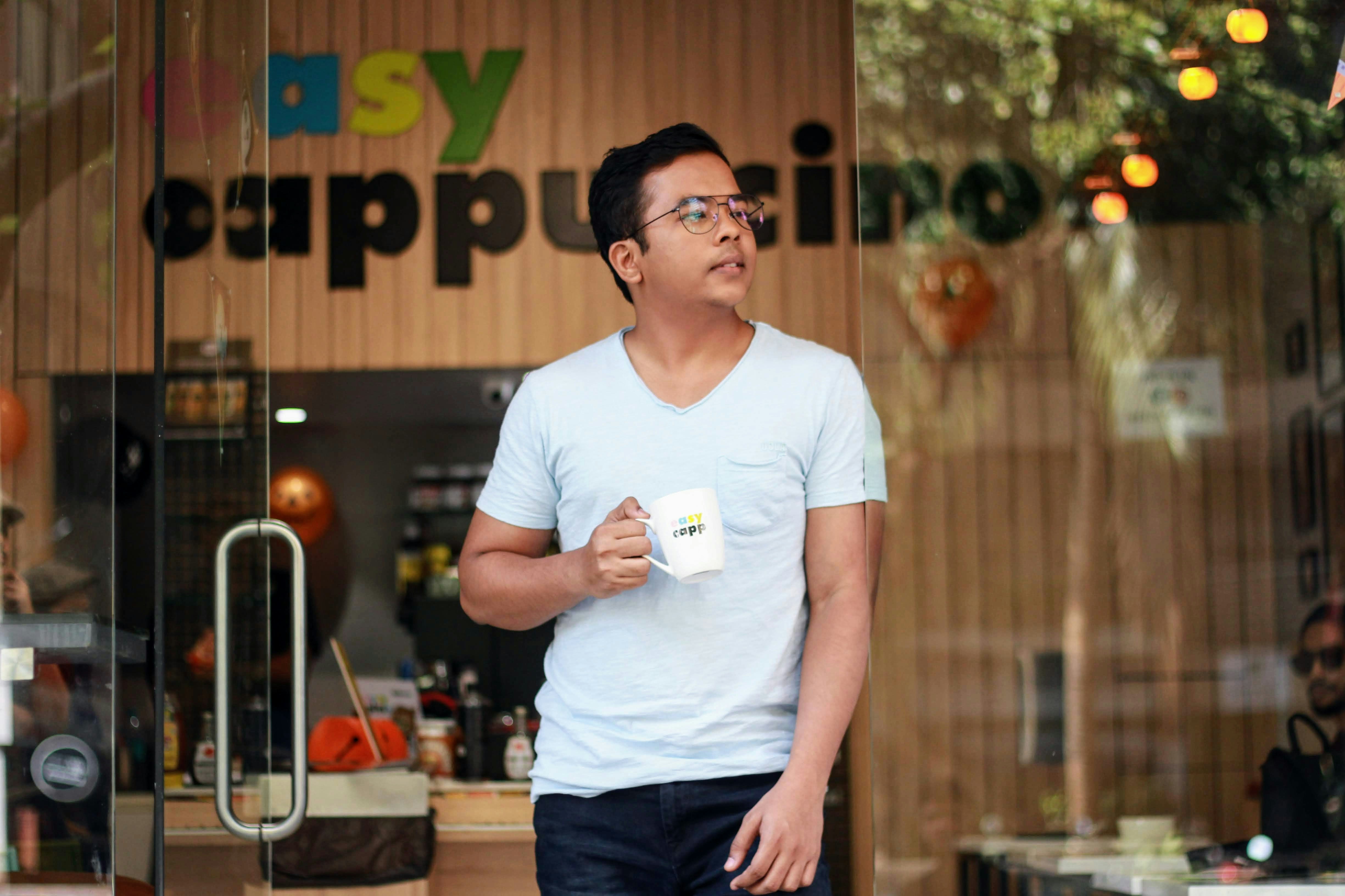A person enjoying morning coffee, representing a positive start to the workday and motivation.