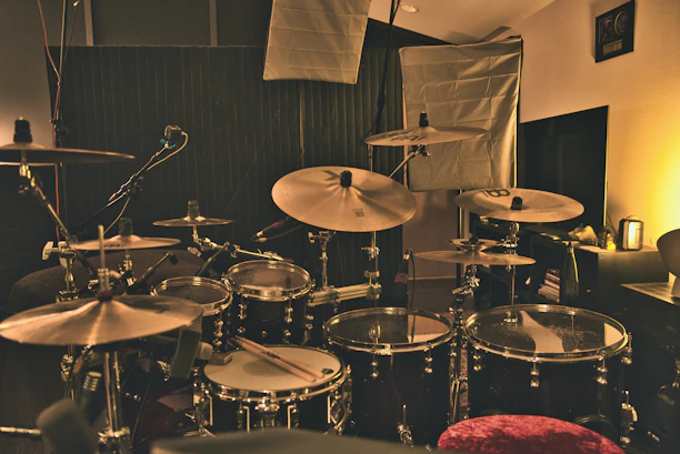 Spacious rehearsal studio with drums and keyboard setup