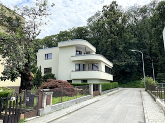 white concrete building near green trees during daytime