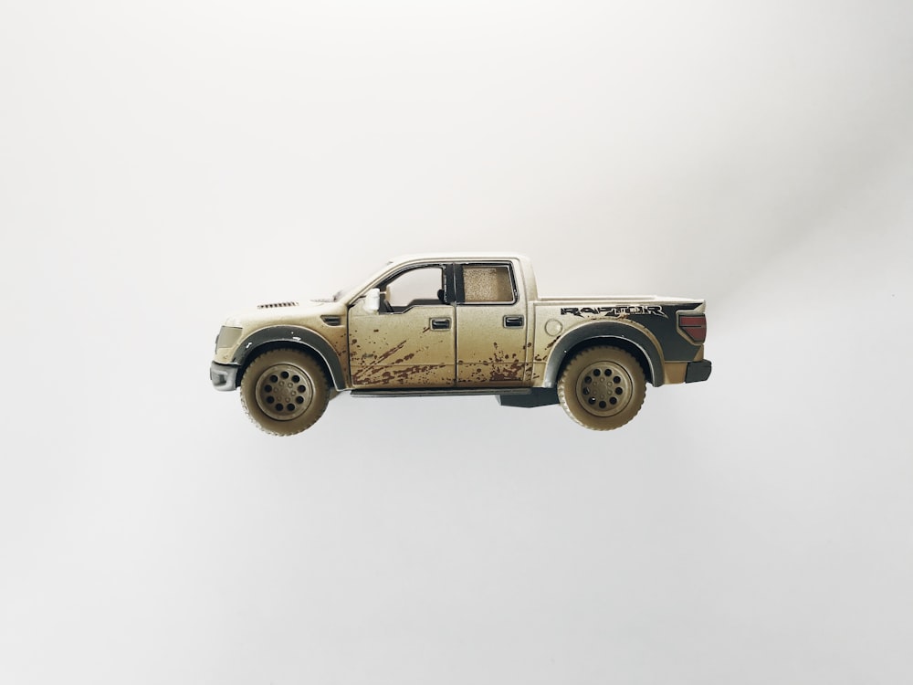 brown and black single cab pickup truck scale model