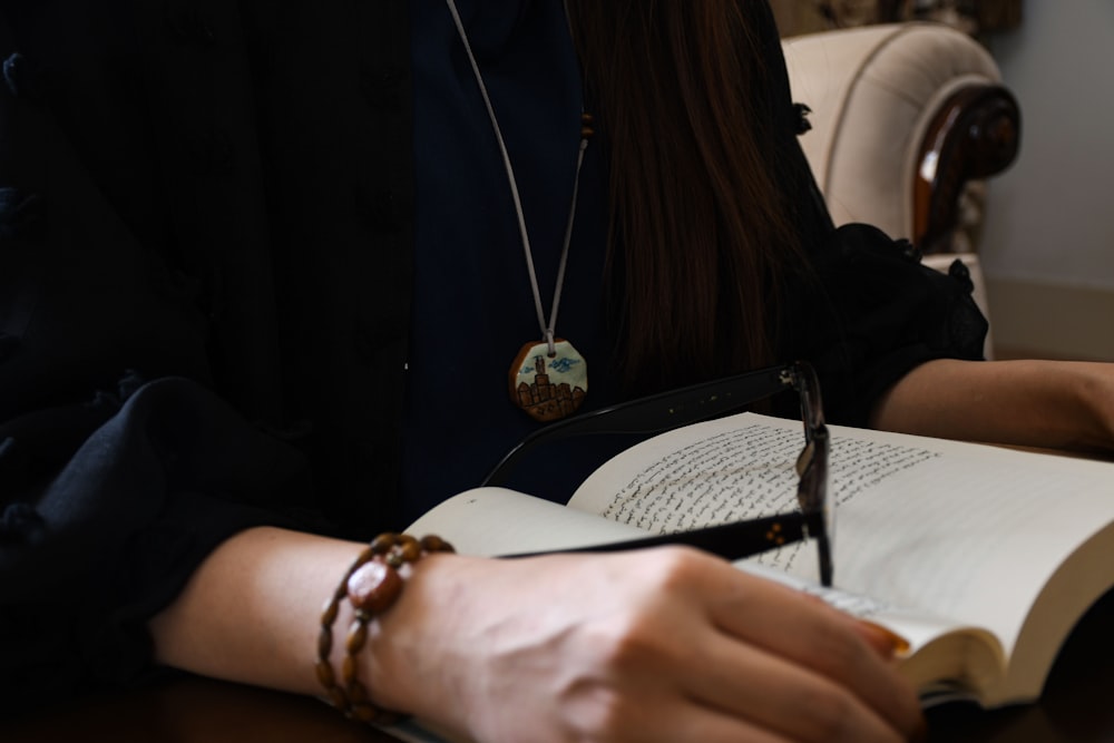 woman in black shirt wearing gold bracelet