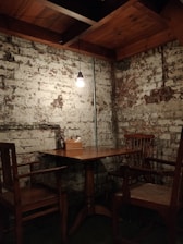 A rustic wooden table set with a sizzling steak, glowing warmly under soft lighting.