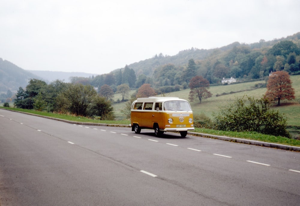 yellow van on road during daytime