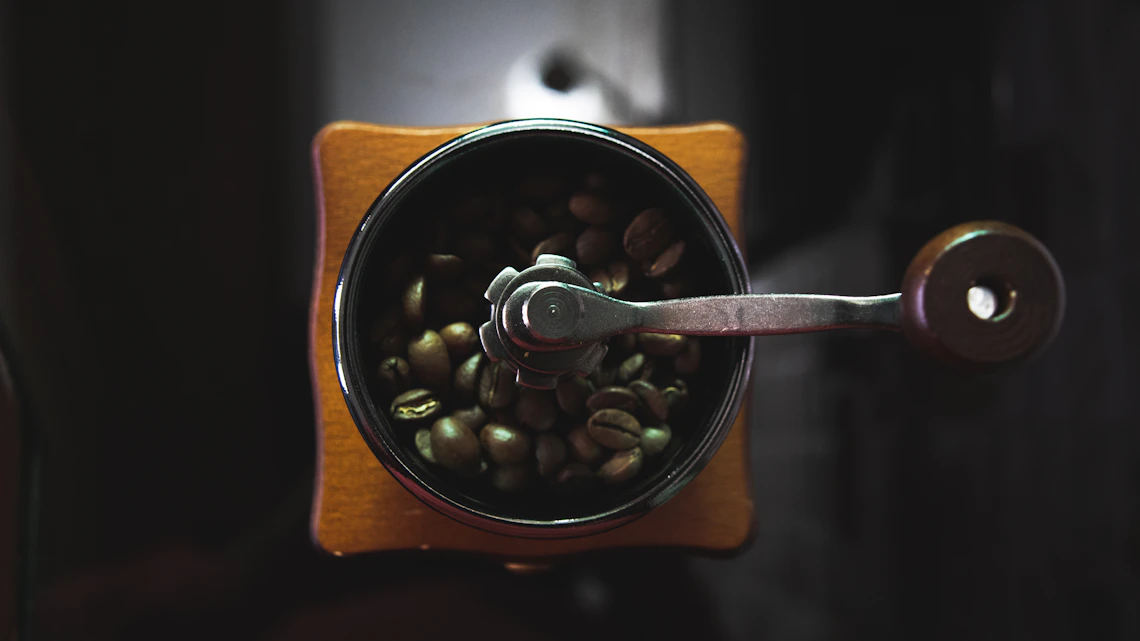 Fresh coffee beans in a grinder before brewing