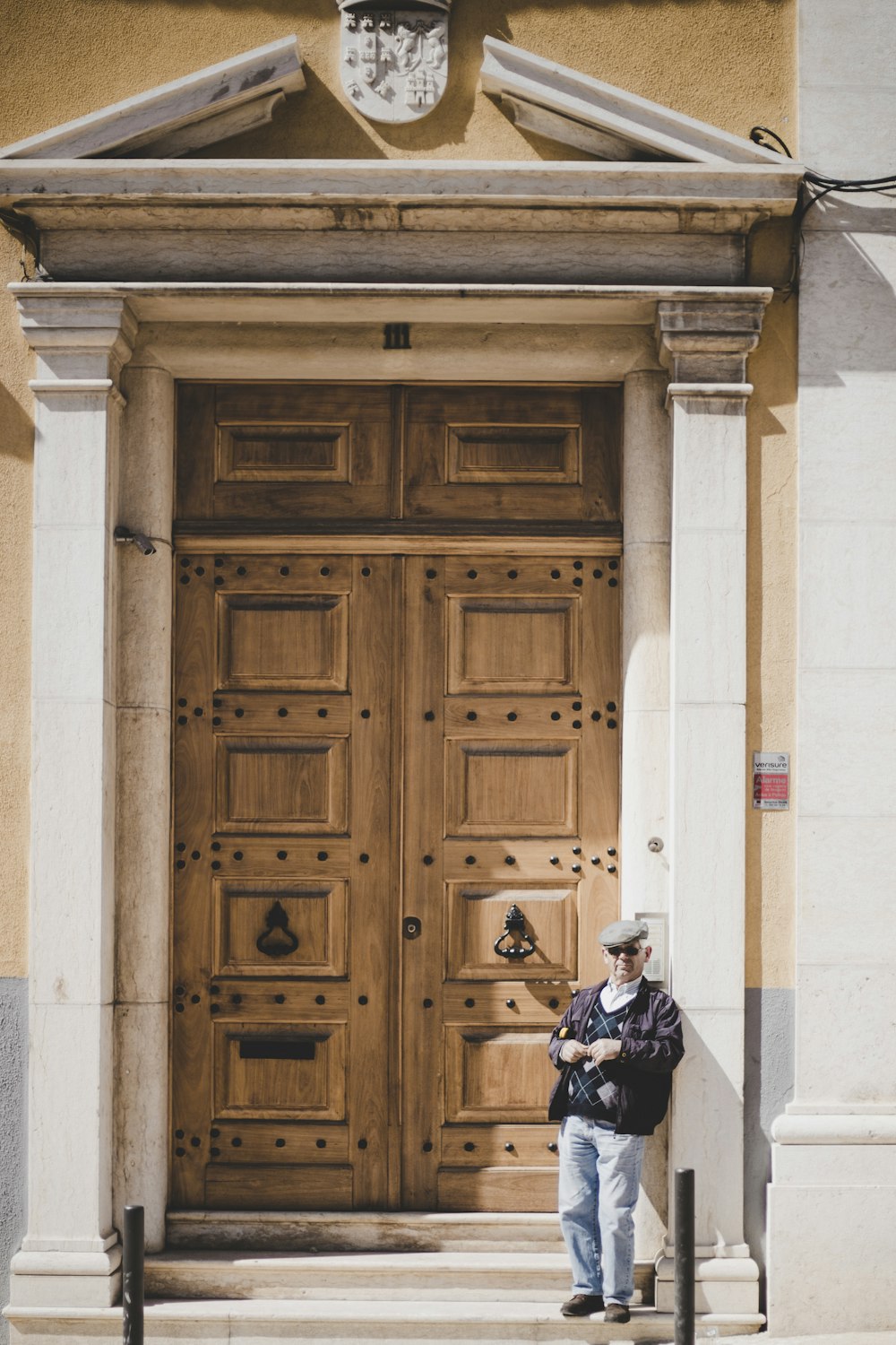a man standing in front of a wooden door