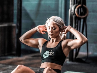 woman in black tank top and black shorts sitting on floor