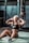 woman in black tank top and black shorts sitting on floor