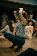 woman in white t-shirt and blue denim jeans sitting on floor