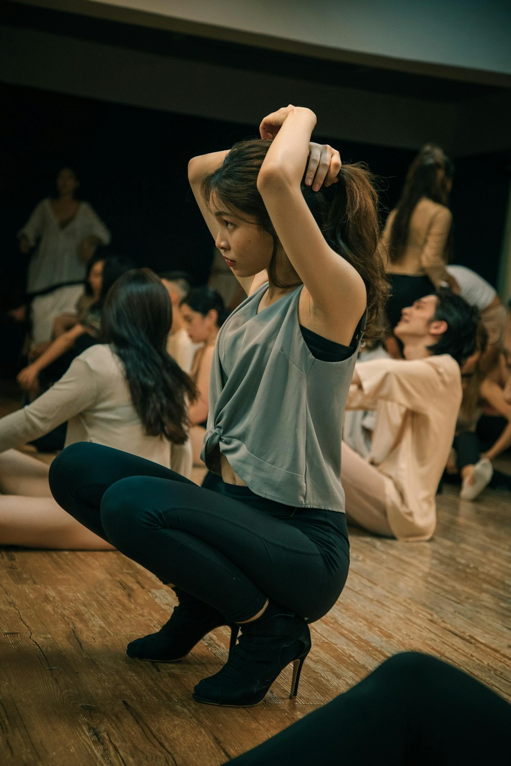 woman in white t-shirt and blue denim jeans sitting on floor