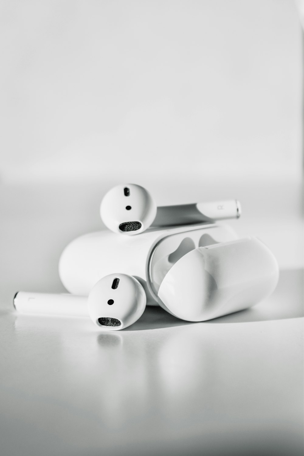 white apple earpods on white surface