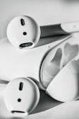 A close-up of stylish wireless earbuds resting on a gym bench.