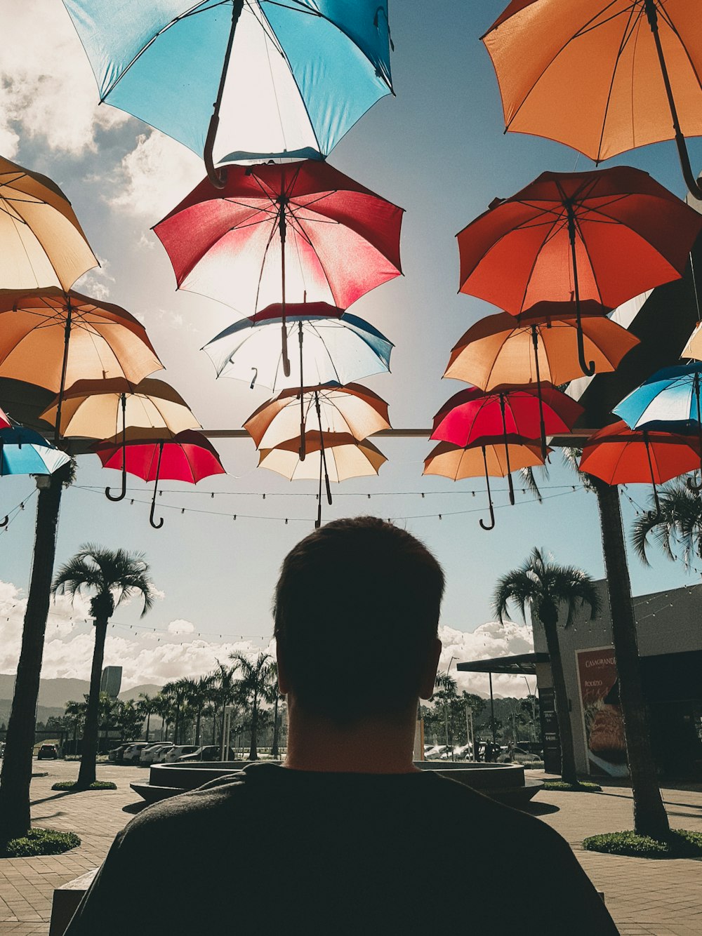 woman under orange umbrella during daytime