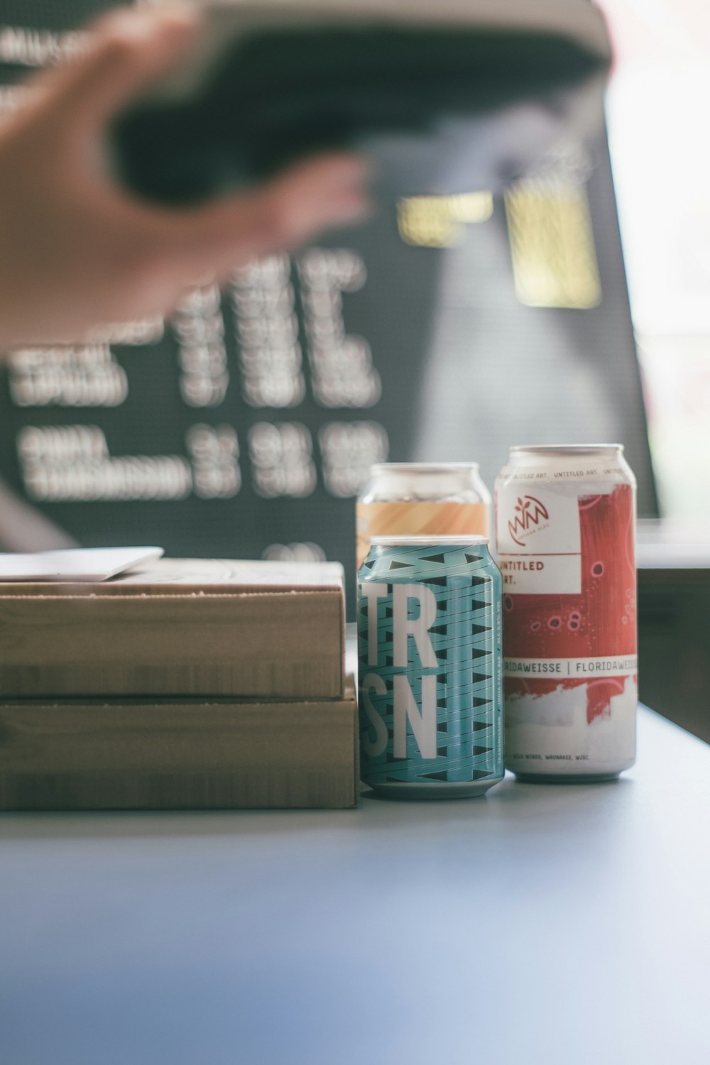 white and red labeled bottle on brown wooden table