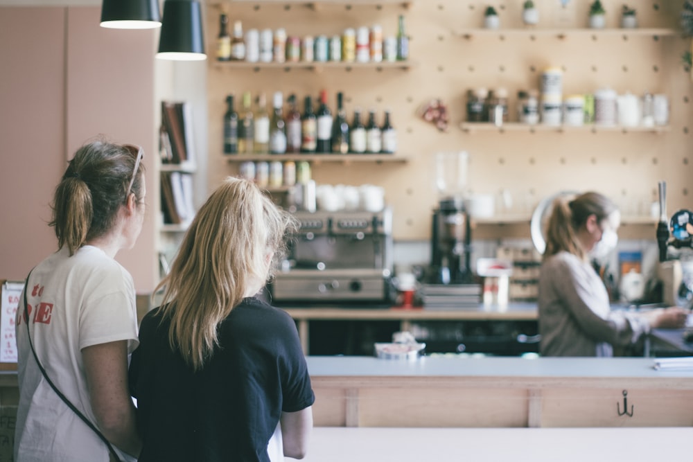 woman in black t-shirt standing near woman in white t-shirt