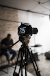 black dslr camera on tripod