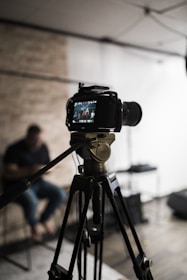 black dslr camera on tripod