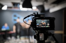 black dslr camera taking photo of city lights