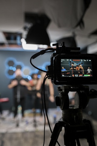 black dslr camera taking photo of city lights