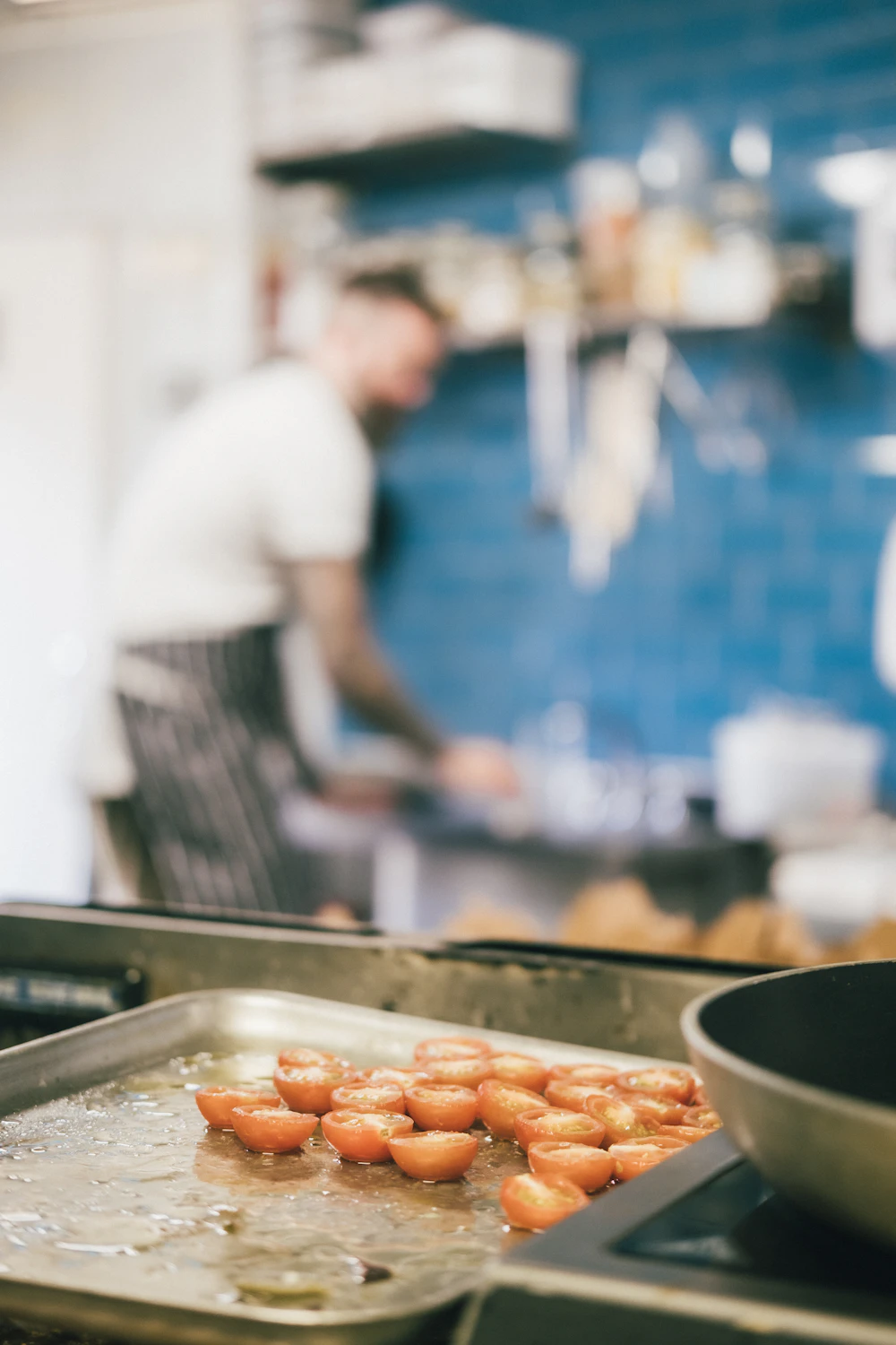 Marco Rossi finishing a plate at the pass