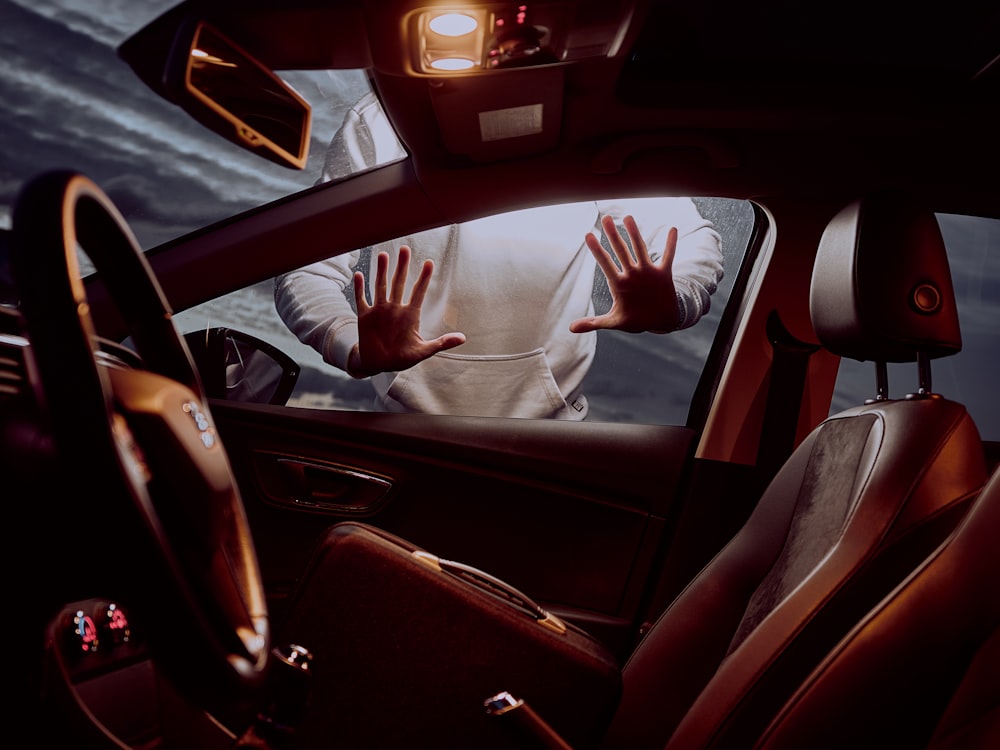 man in white long sleeve shirt driving car