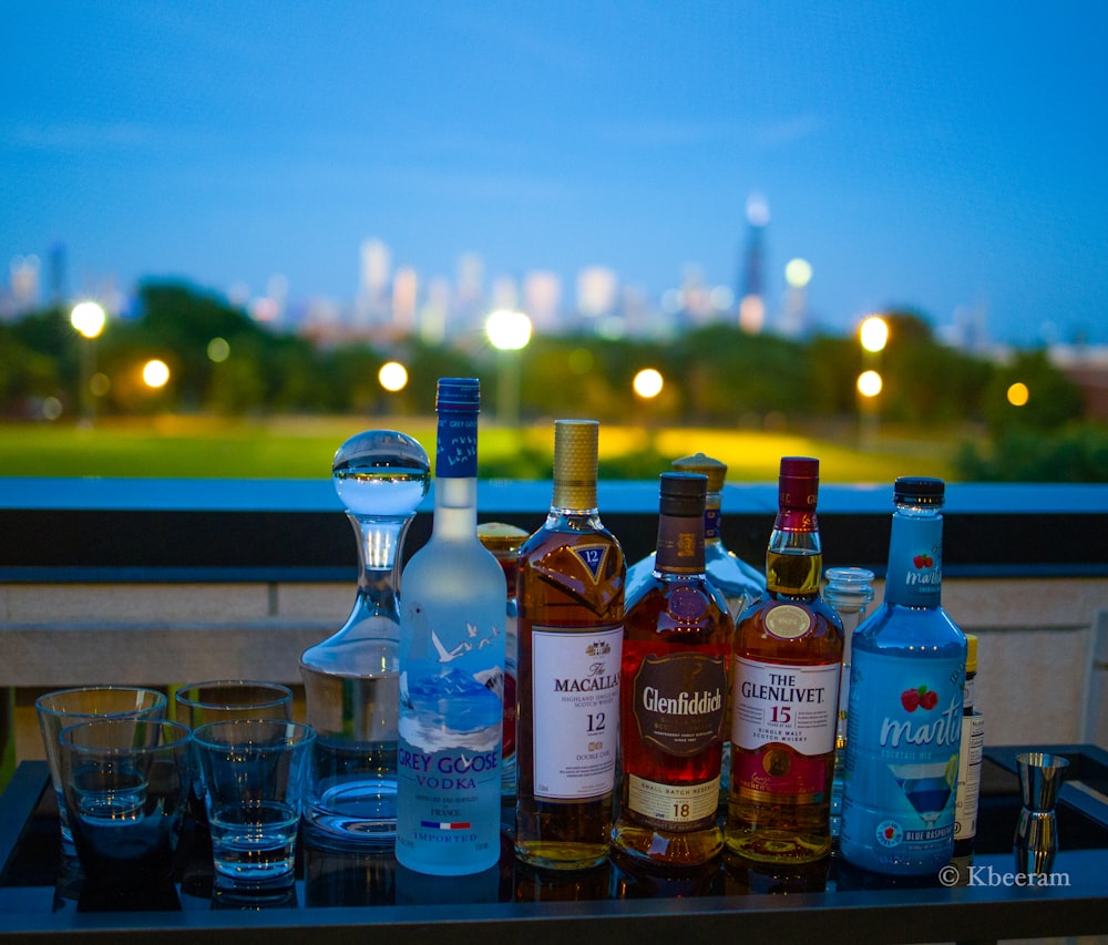 assorted glass bottles on brown wooden table