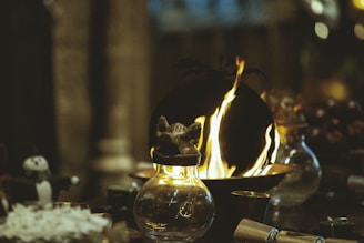 lighted candle in black metal candle holder