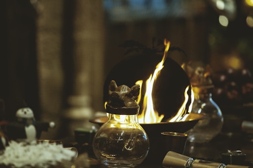 lighted candle in black metal candle holder