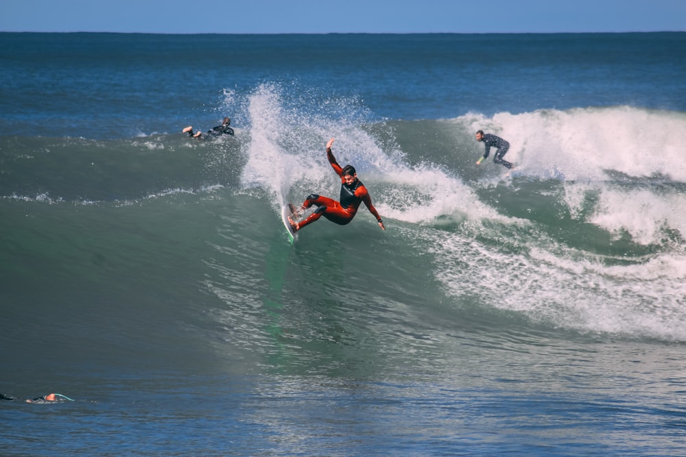 man surfing on sea waves during daytime