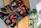 Bright, colorful postcards displayed on a rustic wooden table with splashes of watercolor paint around.