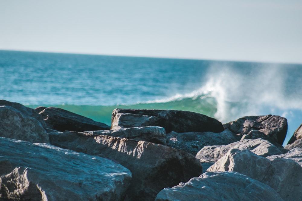 gray rock formation near body of water during daytime