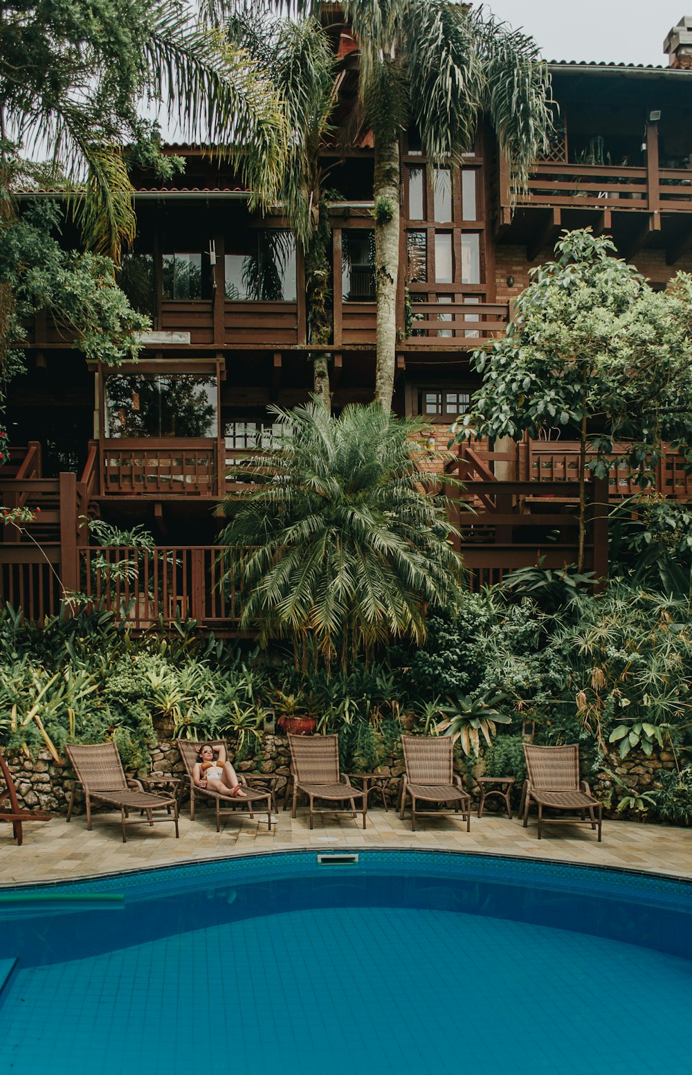 brown wooden building near swimming pool during daytime