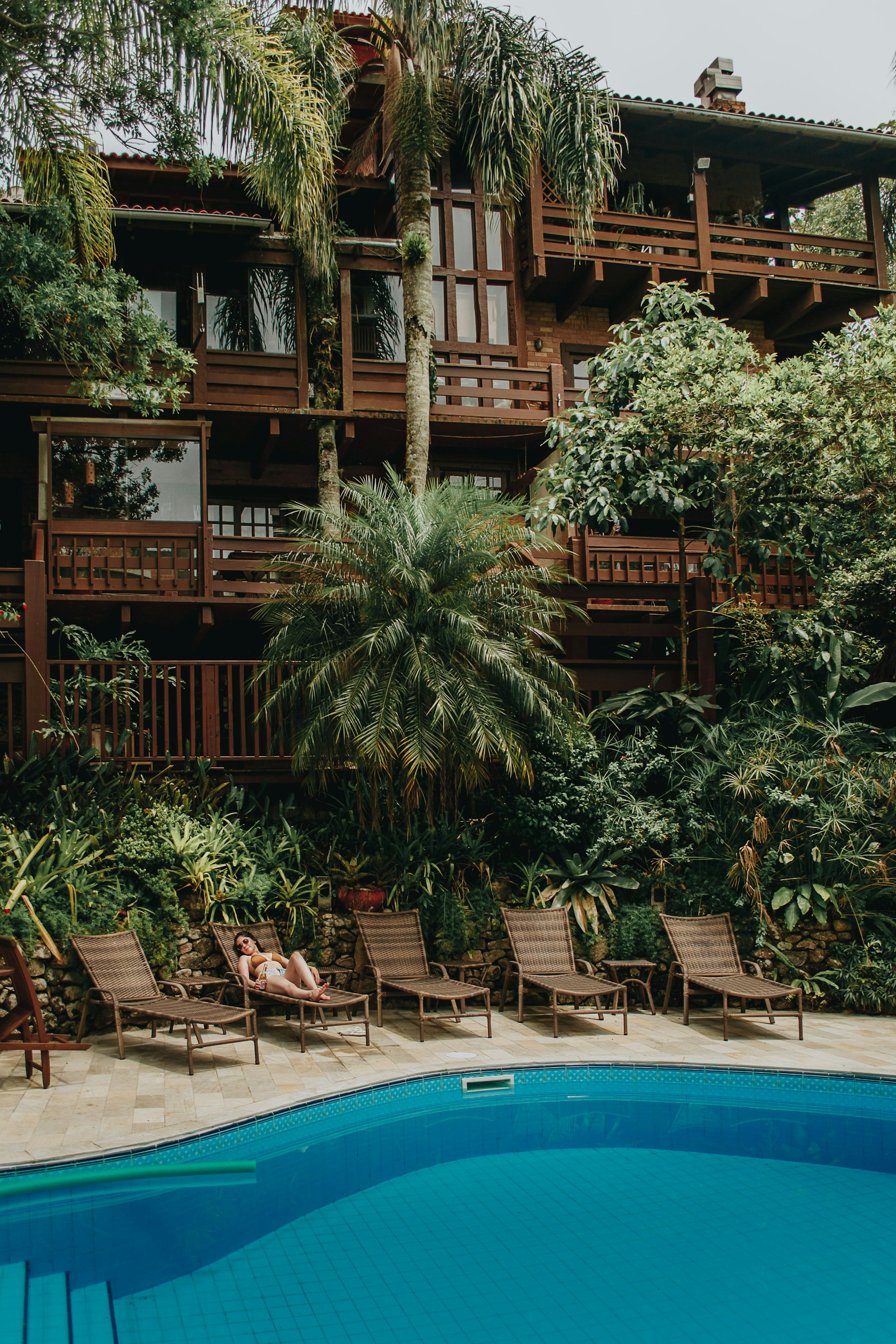 brown wooden house near swimming pool during daytime