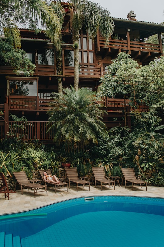 brown wooden house near swimming pool during daytime in Bombinhas Brasil